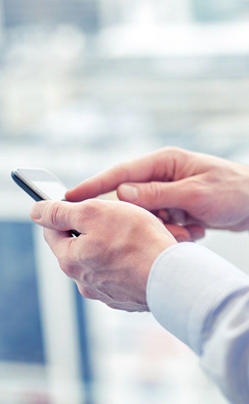 Content_0004_close-up-of-man-hands-with-smartphone-at-office-PJAB2TH.jpg